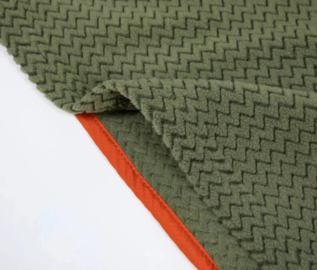 Fleece sweatshirt fabric close-up in olive green with orange trim and wavy texture