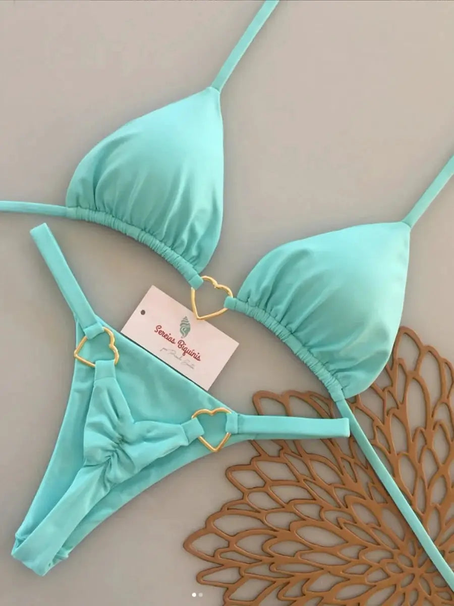 Simples Market turquoise two-piece bikini set with halter top and thong bottom, gold heart ring accents.