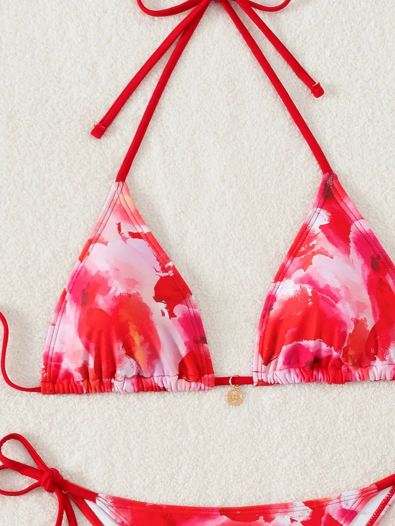 Triangle bikini set in pink-red floral print with red halter straps and Brazilian bottoms by Simples Market