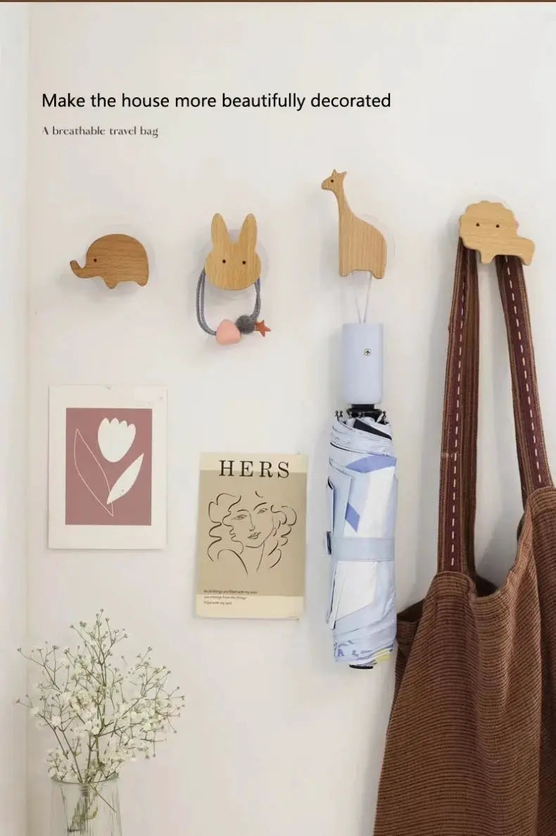 Wooden animal wall hooks for kids' room; four solid wood shapes (elephant, bunny, llama, cloud) with natural finish.