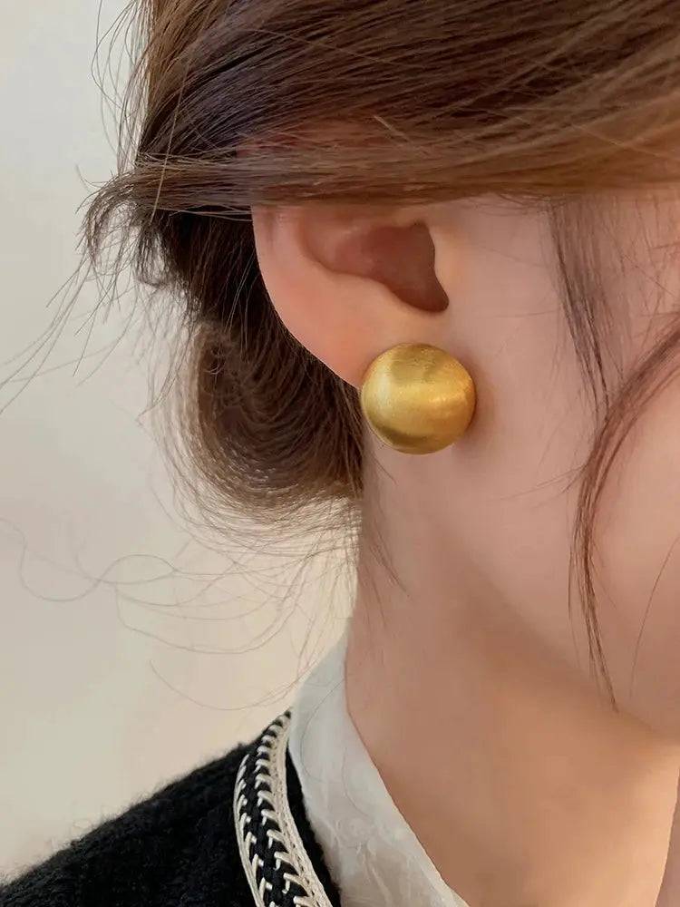 Luxurious brushed frosted metal semicircle earrings in gold tone, large stud style