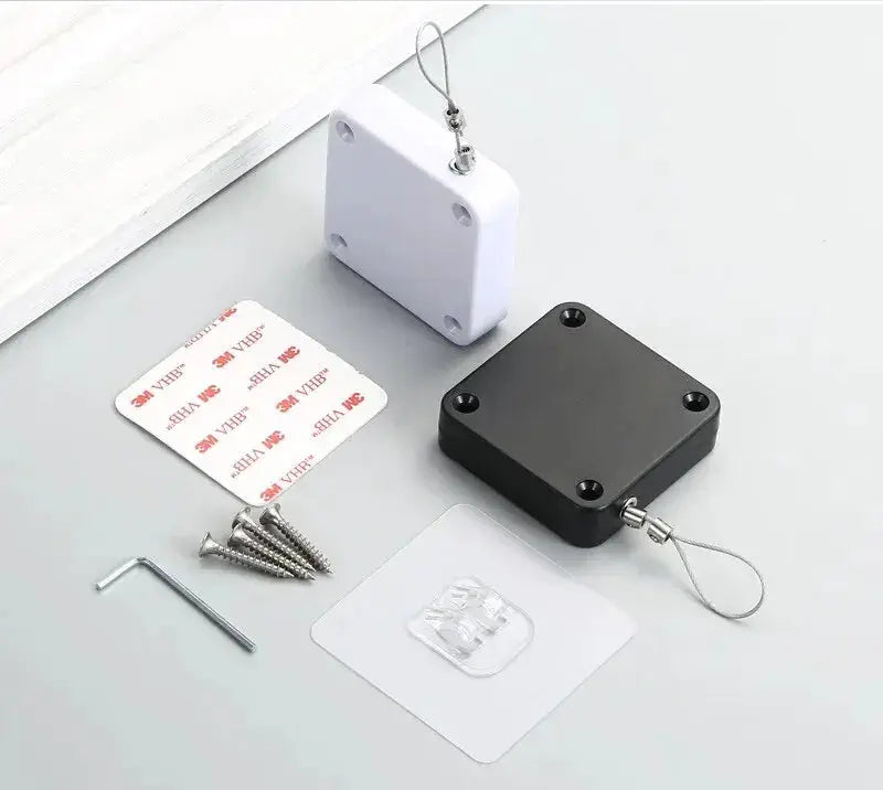 Automatic Drawstring Door Closer by Simples Market; black and white square housings with screws and adhesive pads