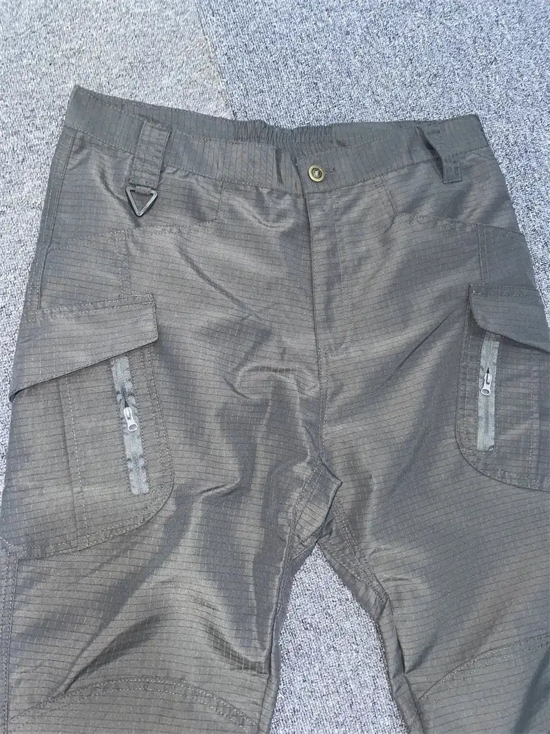Men's dark gray cargo pants with multiple pockets and zippered side pockets