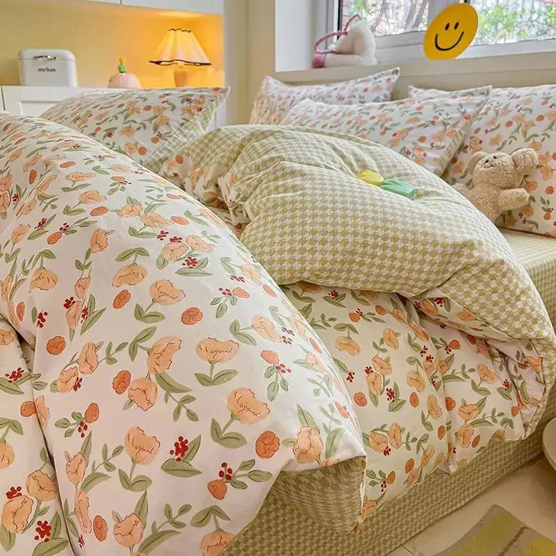 Pink floral bedding set with peach flowers and green leaves; includes duvet cover, flat sheet, and pillowcases, queen