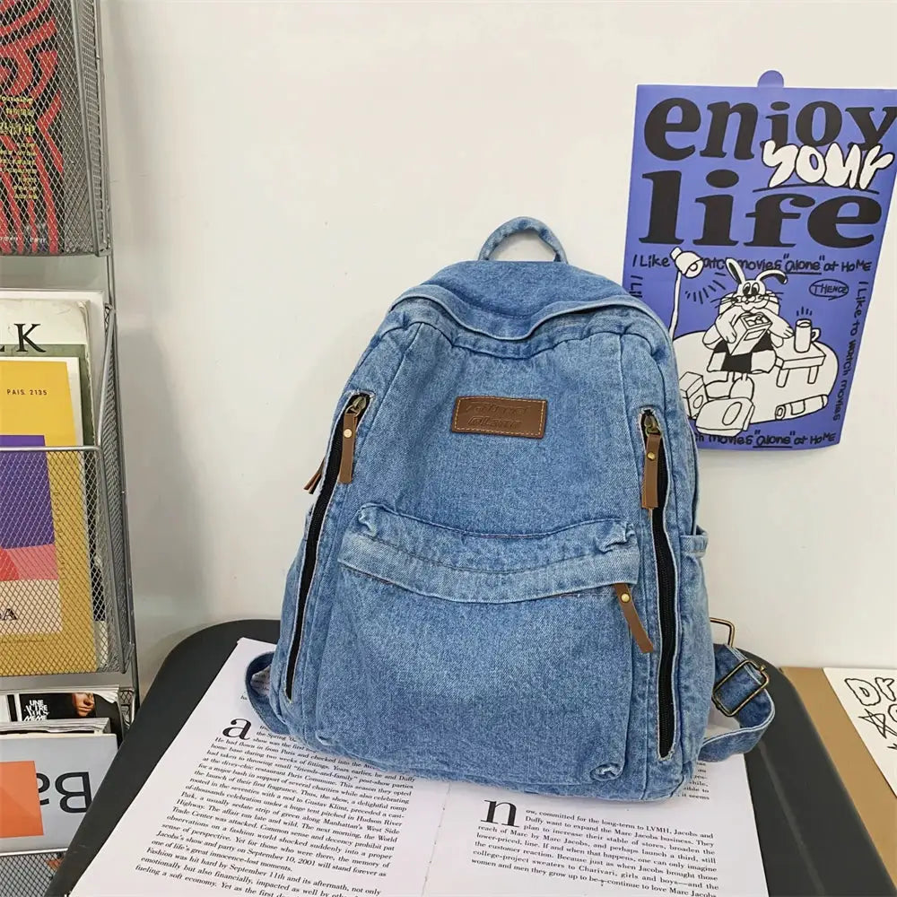 Blue denim backpack by Simples Market with multiple pockets and large capacity