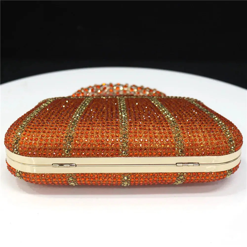 Clutch bag by Simples Market in orange rhinestones with gold-tone frame and long chain