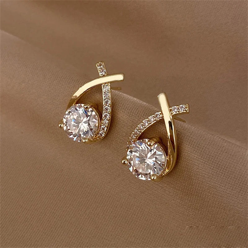 SKEDS gold-tone cross stud earrings for women with large clear crystal centerpiece and pave-accented band
