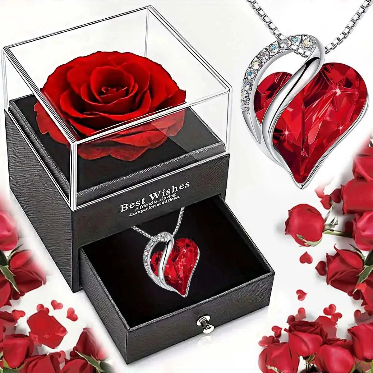 Heart-shaped red crystal necklace with a silver swirl and pave stones in a black jewelry box