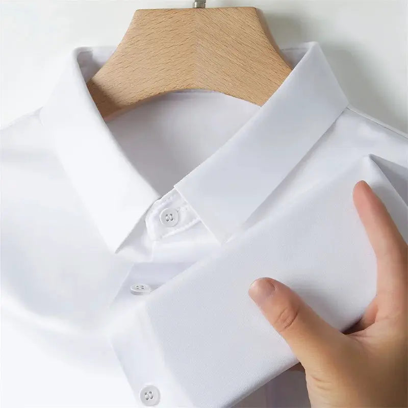 Men's white solid-color dress shirt on a hanger with folded cuff detail
