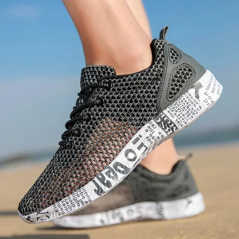 Hight Quality Summer Mens Casual Shoes Aqua Shoes; black mesh sneakers with foam sole and newspaper-print on beach