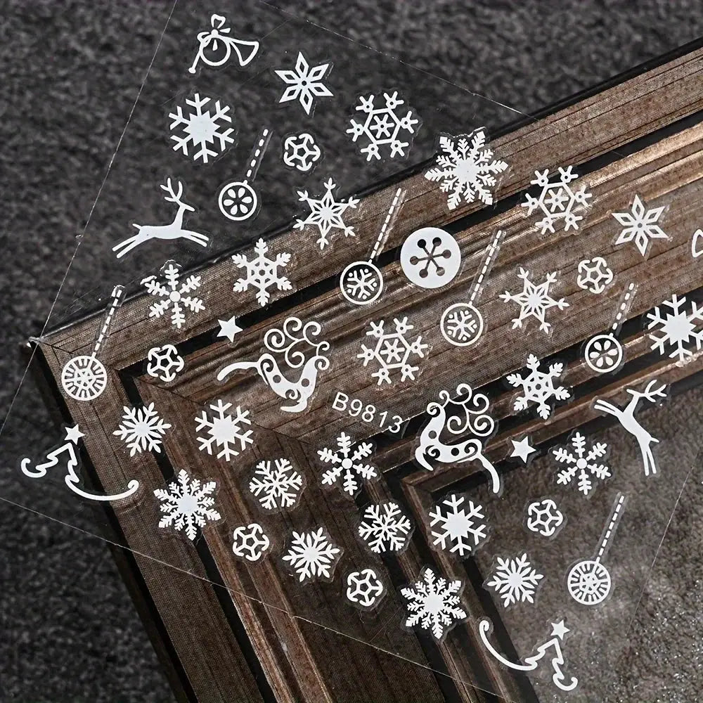 Nail art stickers sheet featuring white Christmas snowflakes, ornaments and reindeer for manicure