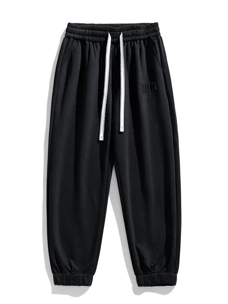 Nike men's black jogger sweatpants with white drawstrings and elastic cuffs