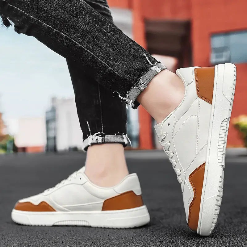 Men's casual white sneakers with tan-brown heel and toe accents