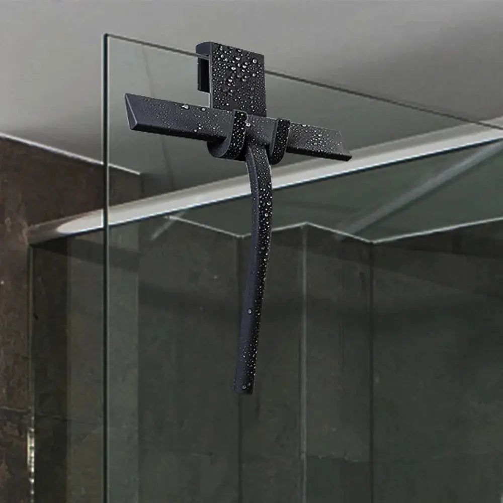 Black shower squeegee with silicone holder mounted on glass door for bathroom cleaning