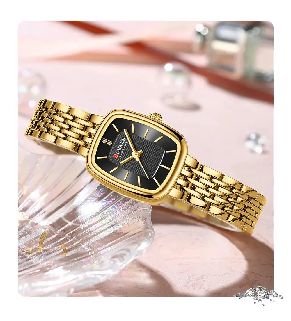 CURRN 9093 gold-tone women's quartz watch with black dial and diamond markers, stainless steel bracelet