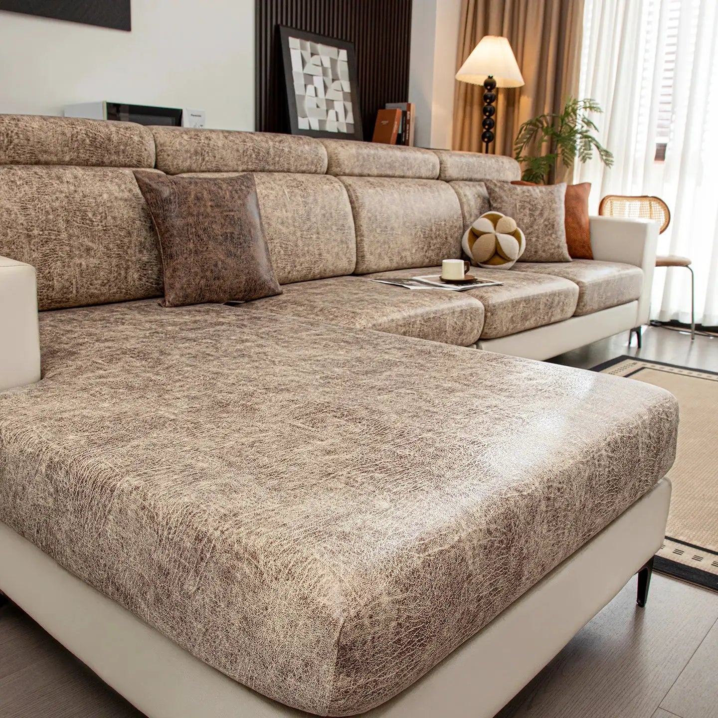 Stretch sofa cover by Simples Market in beige-brown textured fabric on a large living room sofa.