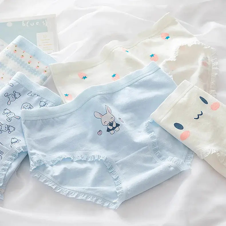 Five pastel blue and white cotton panties by Simples Market with bunny and star prints and lace trim.