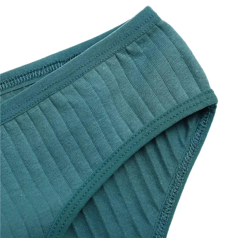 Women's teal cotton panties with ribbed knit texture and matching trim, close-up view