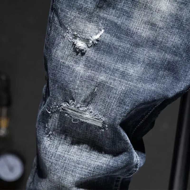 Men's distressed blue cotton denim jeans with ripped knees, slim-fit