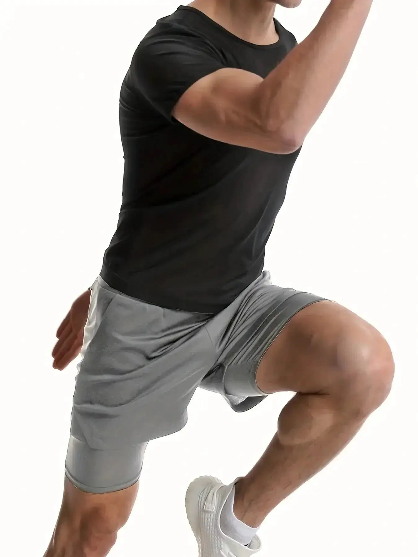 Men's black sauna compression shirt worn by athletic man with gray gym shorts