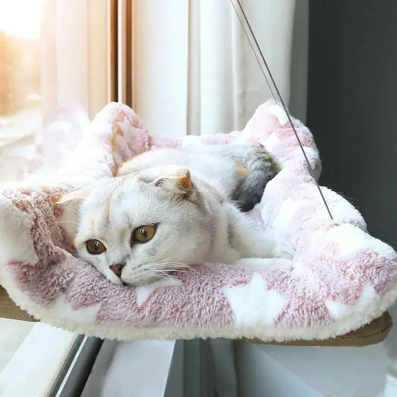 Hanging cat hammock bed in pink plush fabric with 20 kg capacity by sunny window