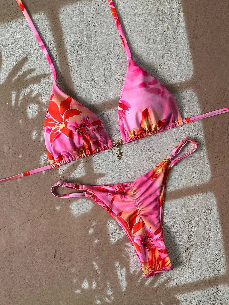 Pink floral two-piece bikini set with triangle top and thong-style bottom, adjustable straps