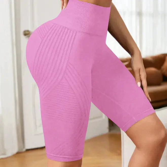 Simples Market pink high-waisted seamless yoga shorts with knit panels, mid-thigh length.