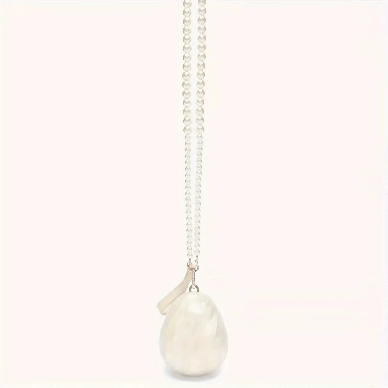 Pearl pendant necklace on a long silver chain with a large white irregular pearl