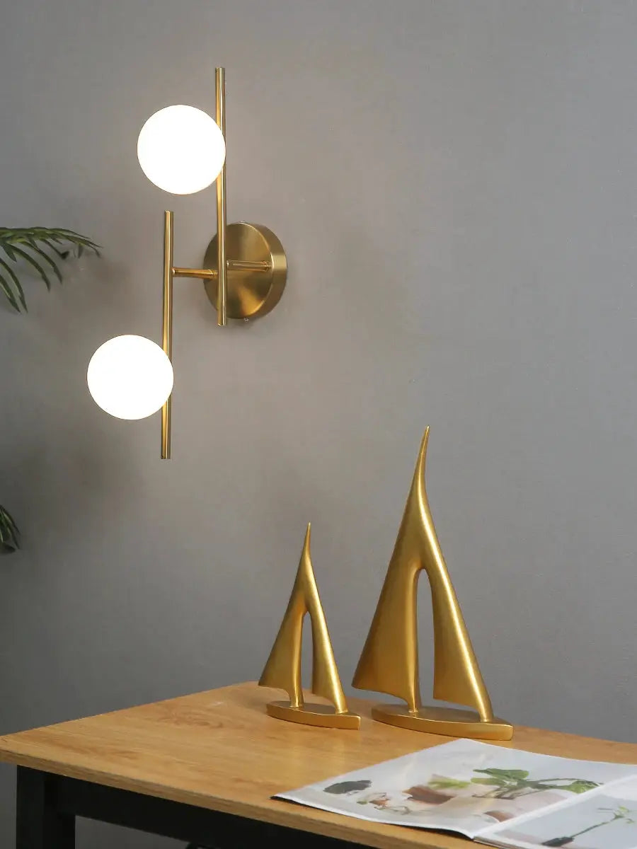 Simples Market modern gold LED wall lamp with two milky glass globes, double-arm design.