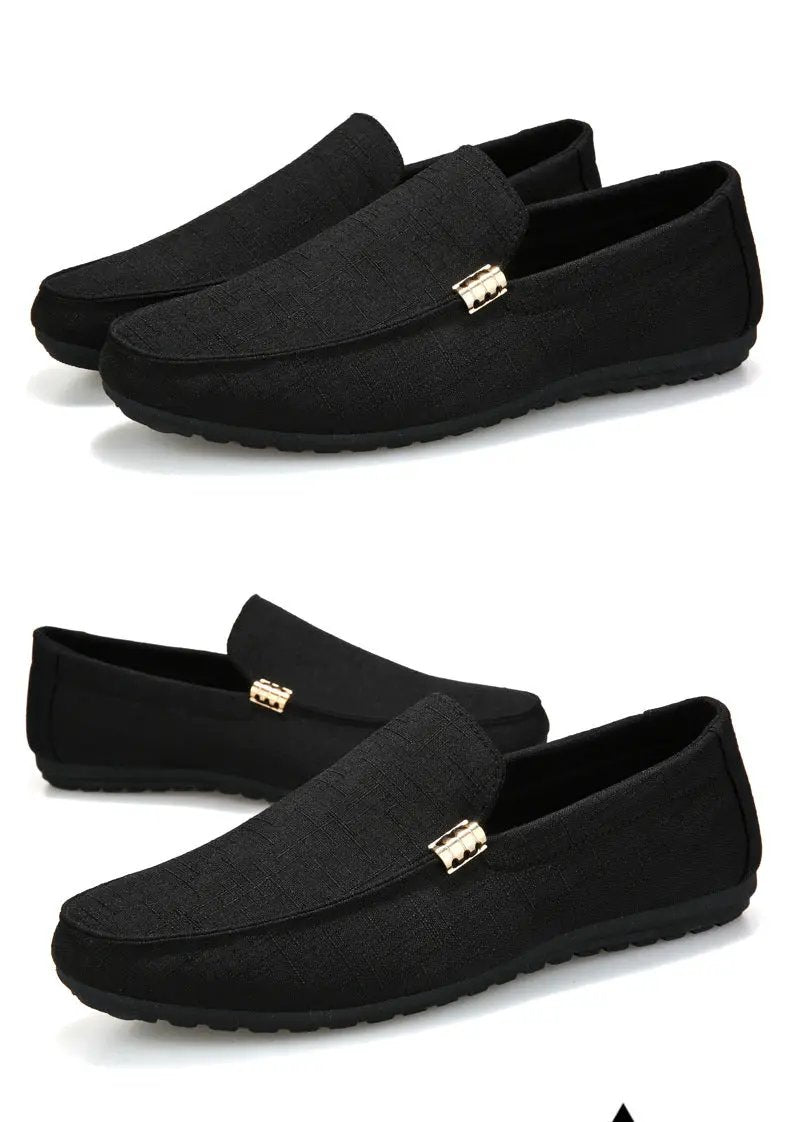 Men's black canvas slip-on loafers with gold buckle accent; casual dress driving shoes, rubber sole.
