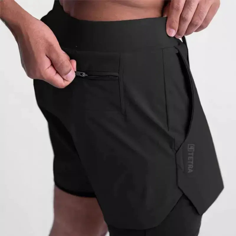 ASRV 2-in-1 black athletic shorts with zip pocket; double-deck design and curved hem.
