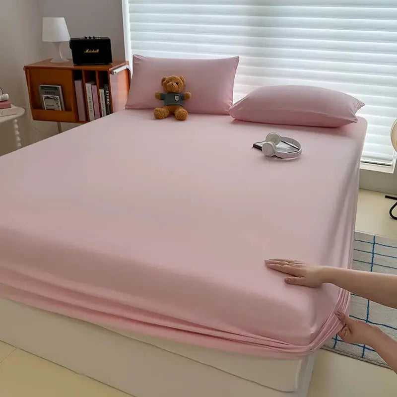 Washed pink fitted sheet with elastic corner bands, non-slip mattress cover.
