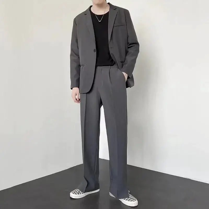 Men's gray straight baggy suit pants worn with matching blazer, casual streetwear style