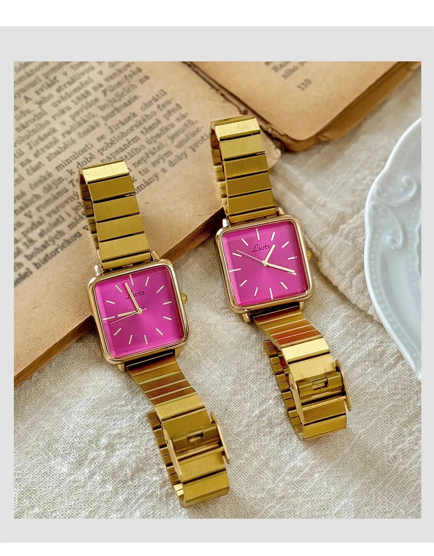 Two gold-tone square-dial women's watches with stainless steel bands and pink faces