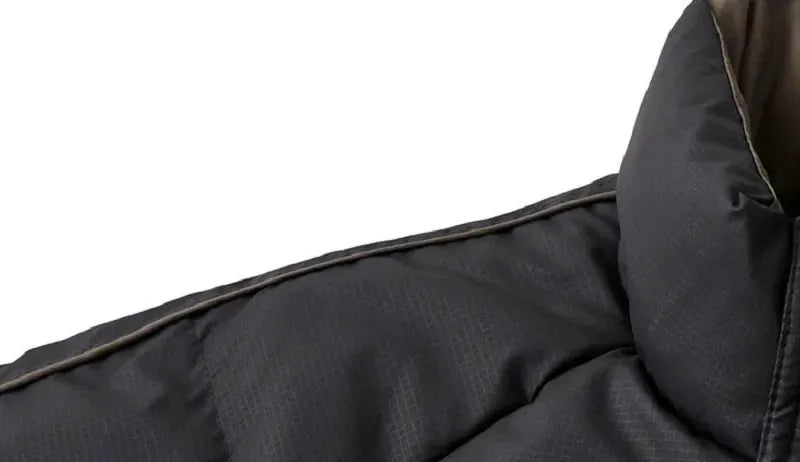 Black men's puffer jacket with brown piping along the shoulder seam, close-up of quilted collar.