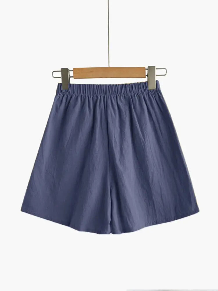 Women's linen shorts on a hanger in blue with an elastic high-waisted waistband.