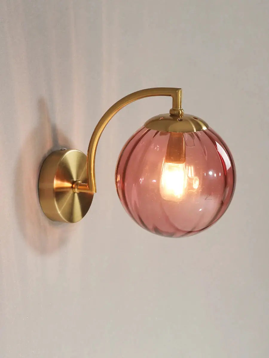 Modern LED wall lamp with pink glass globe and brass curved arm, Simples Market