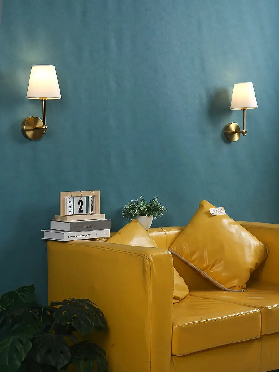 Simples Market American Retro wall lamps; brass finish with white fabric shades, pair on blue wall
