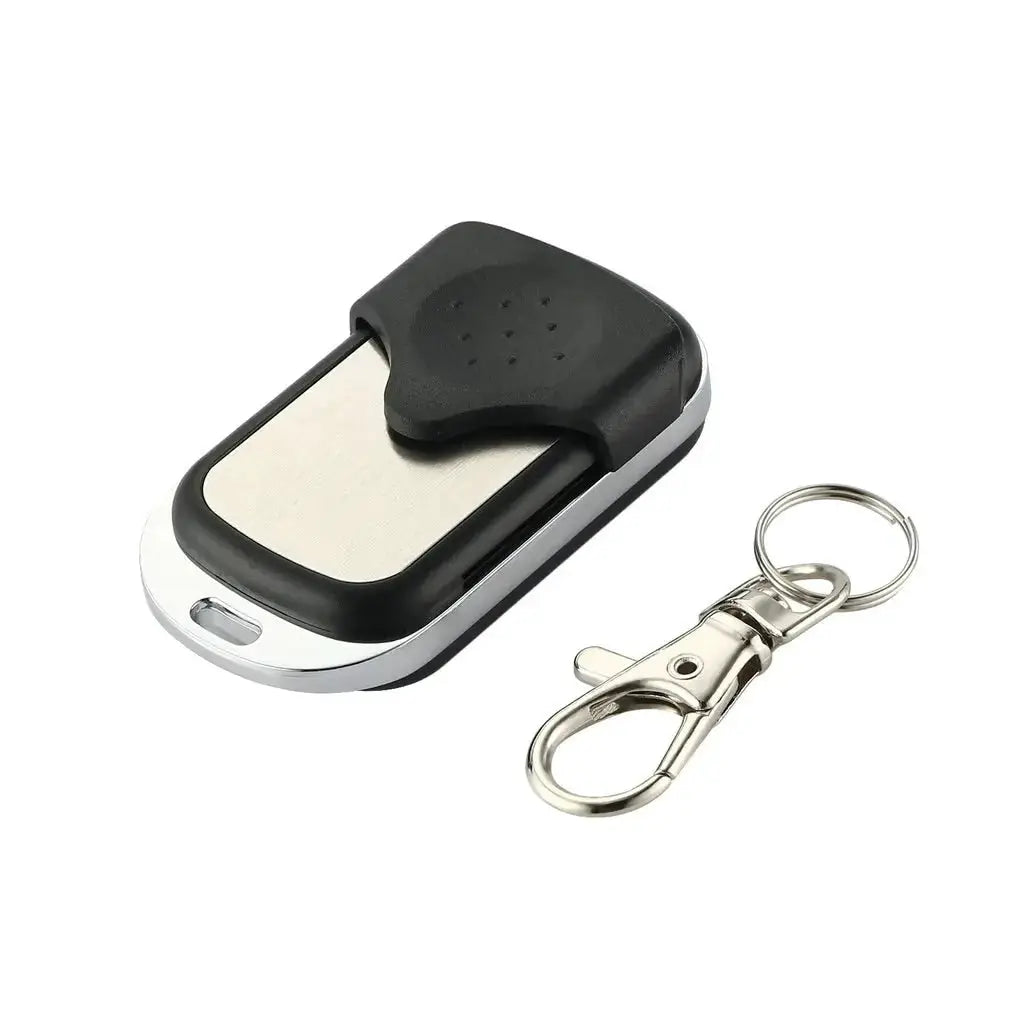 Garage door remote control by Simples Market; black and silver with metal panel, includes keychain
