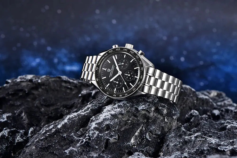 PAGANI DESIGN men's chronograph watch on rocky surface; stainless steel bracelet, black dial with tachymeter bezel