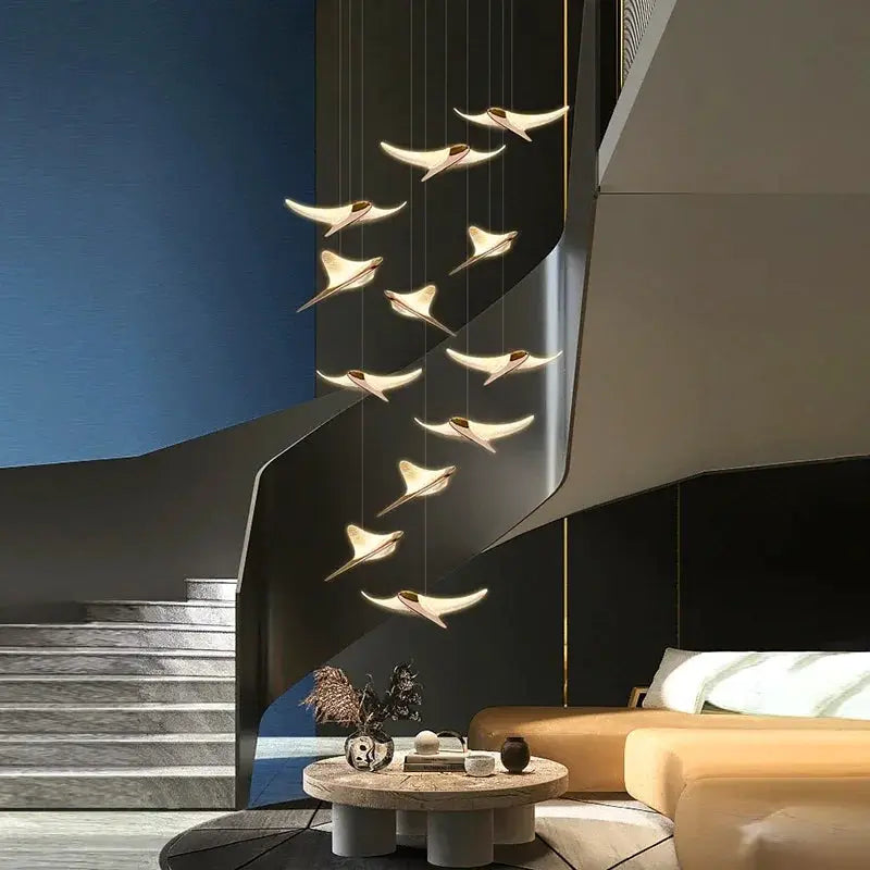 Seagull Staircase Pendant Lamp by Simples Market, cascading gold-tone bird pendants with warm glow along a staircase