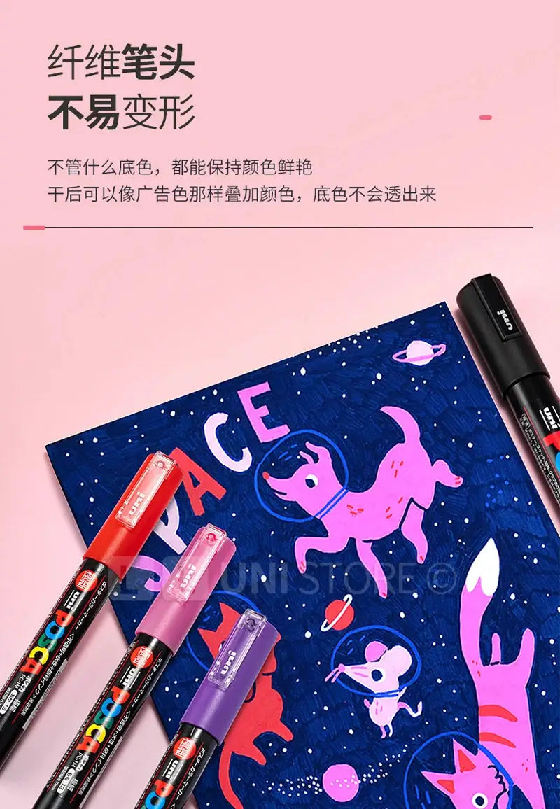 Uni Posca paint marker pens set with five markers in red, pink, lilac, purple and black beside a space poster