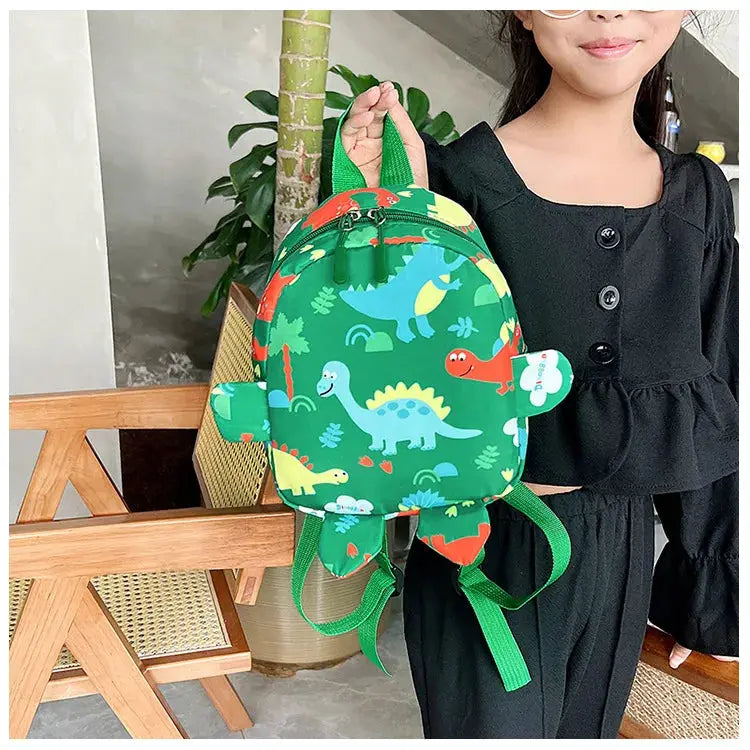 Dinosaur kids backpack in green with colorful cartoon dinosaurs and adjustable straps