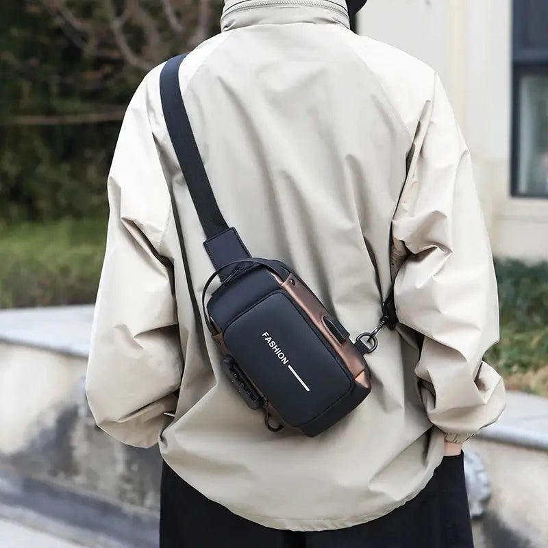 Men's anti-theft chest bag crossbody with USB charging, black with bronze trim.