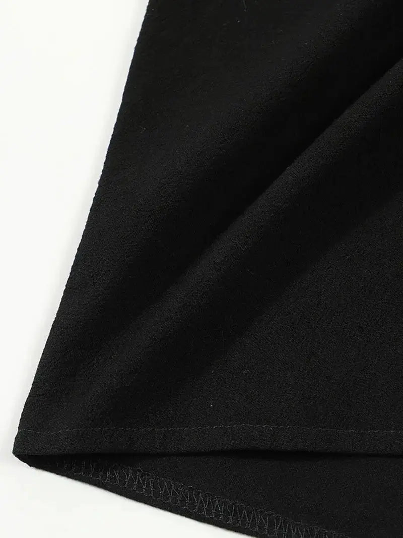 Men's black linen short-sleeve shirt close-up fabric texture and hem.
