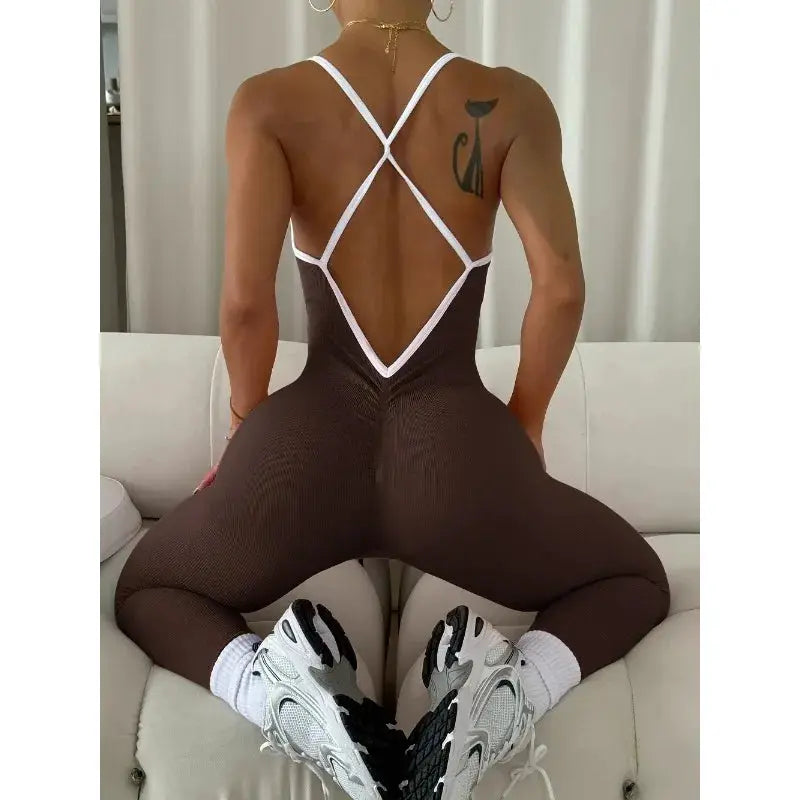 Women seamless ribbed brown sports jumpsuit with white cross-back straps for gym workouts