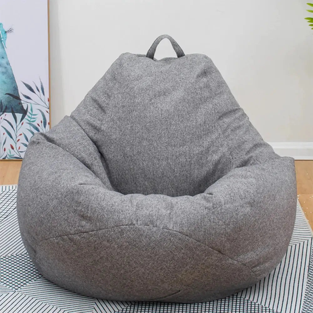 Large gray linen bean bag lounger chair without filler in living room