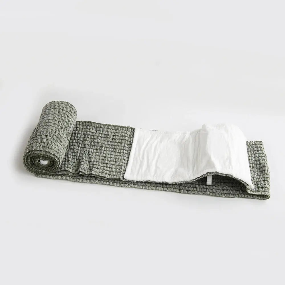Israeli Bandage trauma wrap by Simples Market with white gauze pad on gray woven fabric