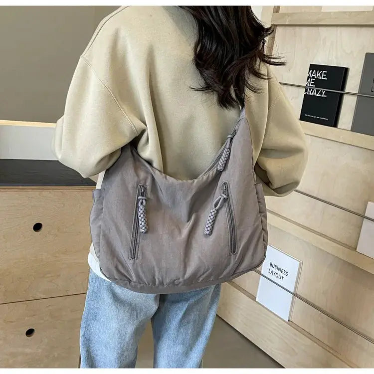 Trendy women's soft gray cloth shoulder bag, large crossbody tote with dual front zips and rope pulls