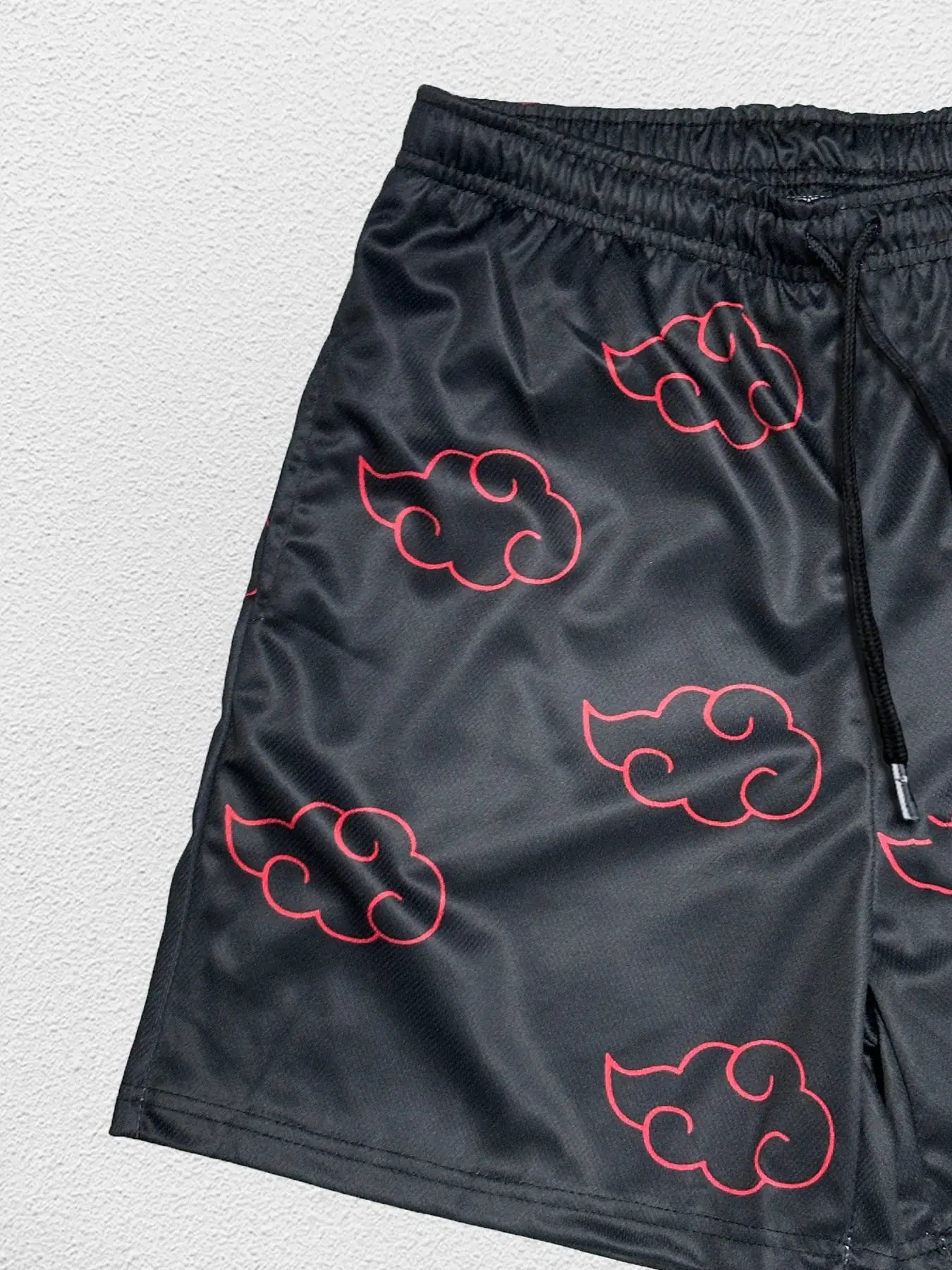 Men's black anime-style running shorts with red cloud print, elastic waistband and drawstring